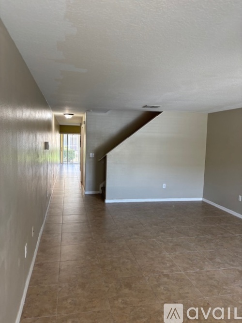 A room with a ceiling fan and carpeted floor.