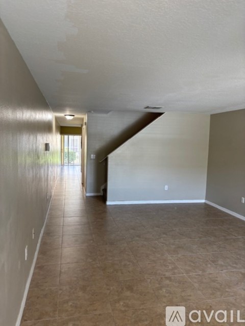 A room with a ceiling fan and carpeted floor.