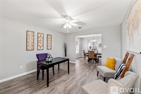 A living room with a dining table and chairs.