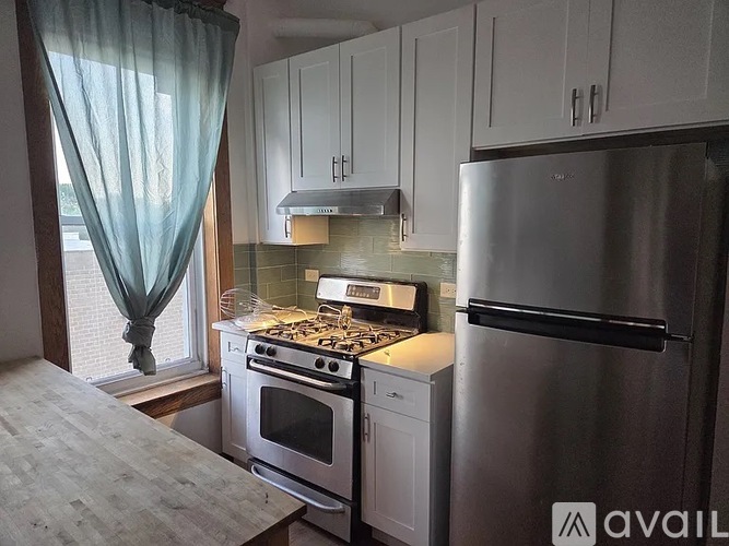 A kitchen with a stove, oven, and refrigerator.