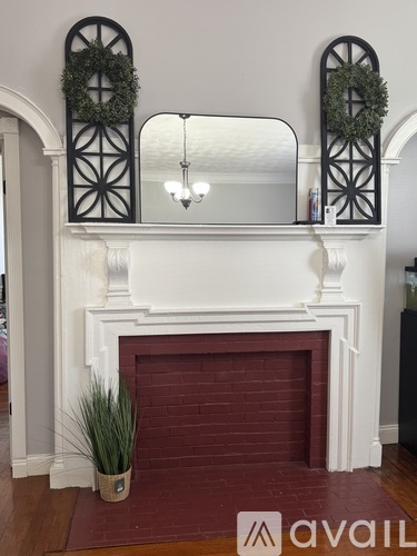A fireplace with a wreath on top of it.