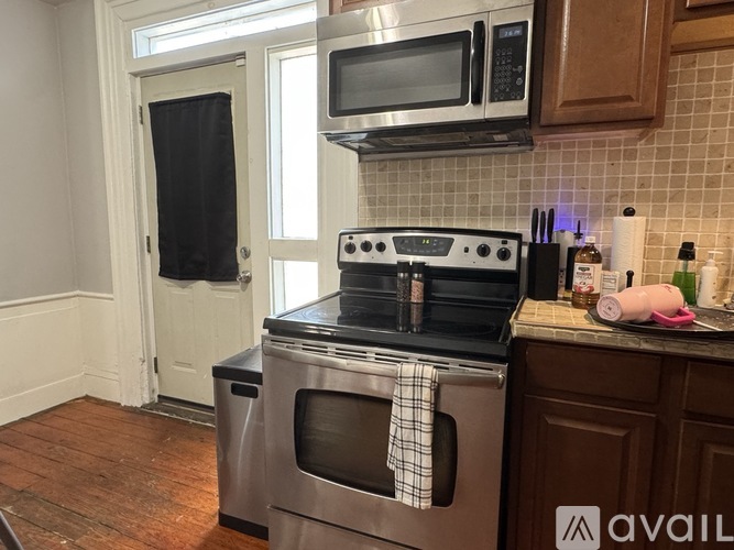 A kitchen with a stove, oven, and microwave.