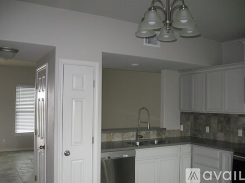 A kitchen with a sink and a counter.