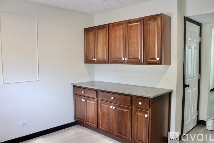 A kitchen with brown cabinets and a white countertop.