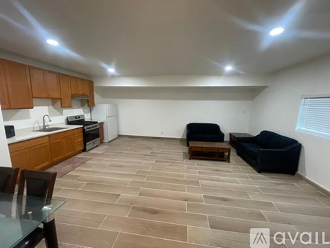 A kitchen with a dining table and chairs is visible.