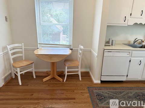 A kitchen with a table and chairs in it.