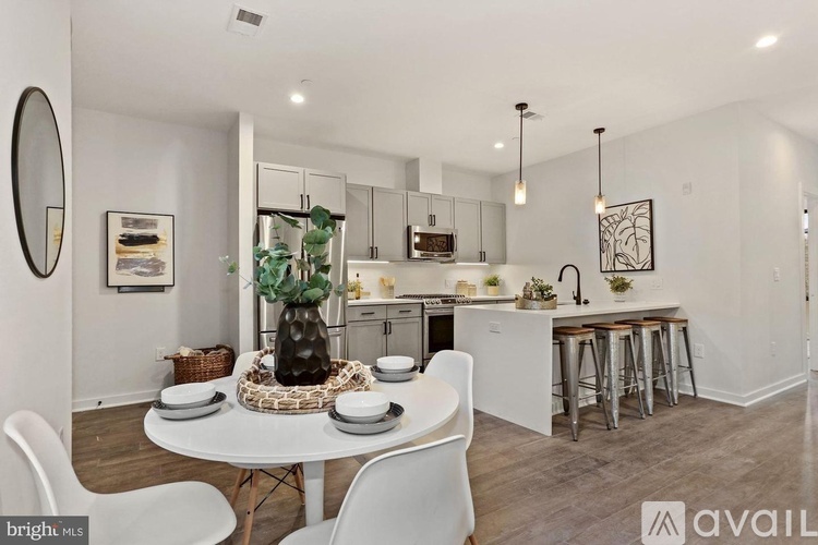 A modern kitchen with a dining table set for two.