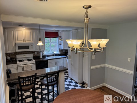 A kitchen with a black and white checkered floor.