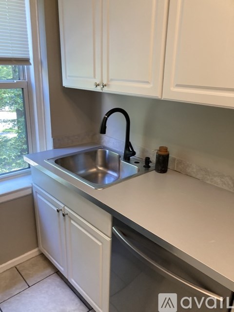 A kitchen with a sink and a window.