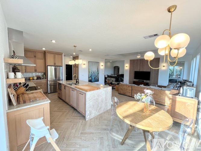 A modern kitchen with a dining table and chairs.