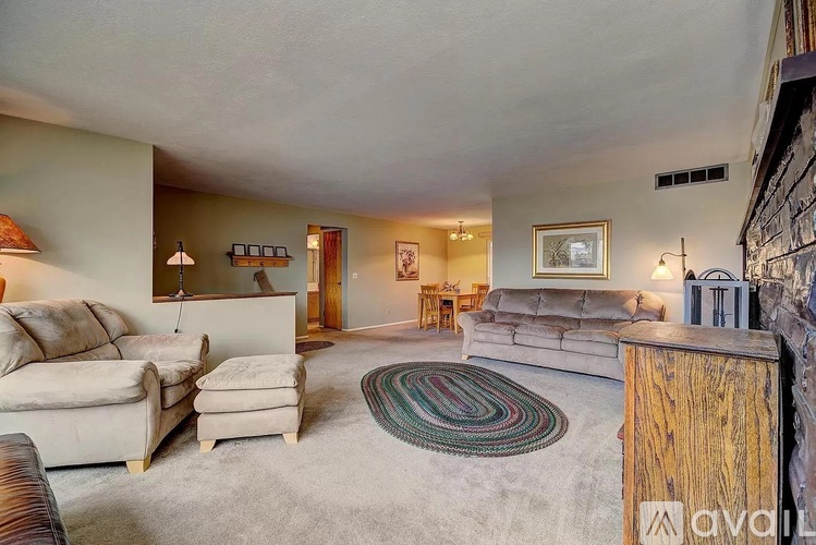 A living room with a rug and a couch.