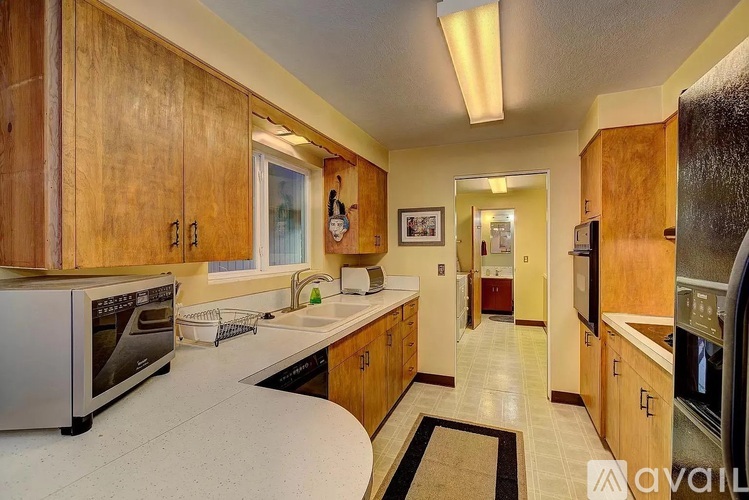 A kitchen with wooden cabinets and a white countertop.