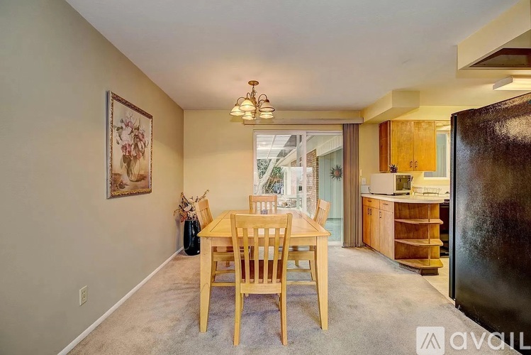 A dining room with a table and chairs is shown.