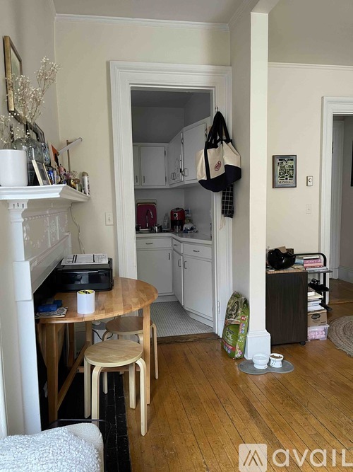 A kitchen with a table and chairs in the middle of the room.