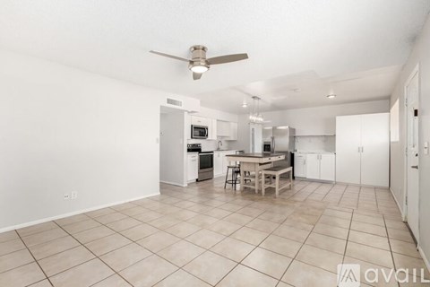 A spacious kitchen with white cabinets and a central island.