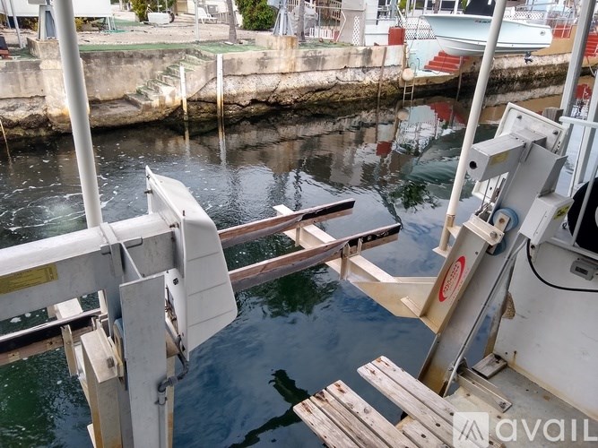 A boat is docked at a pier with a metal railing.