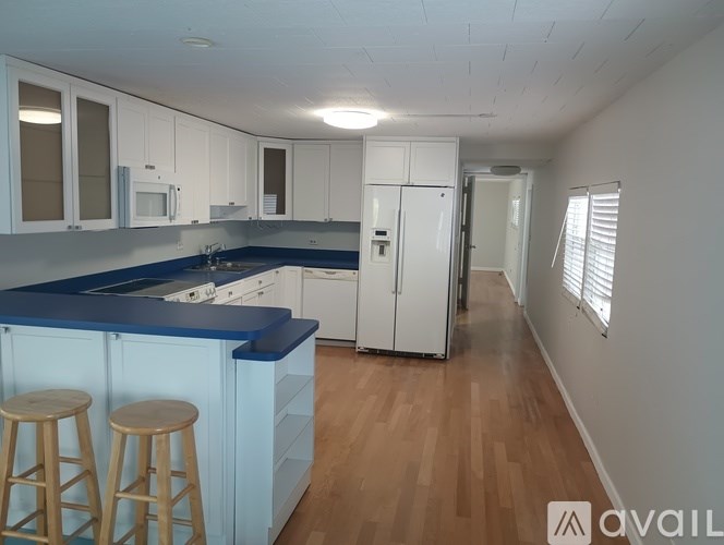 A kitchen with white cabinets and a blue countertop.