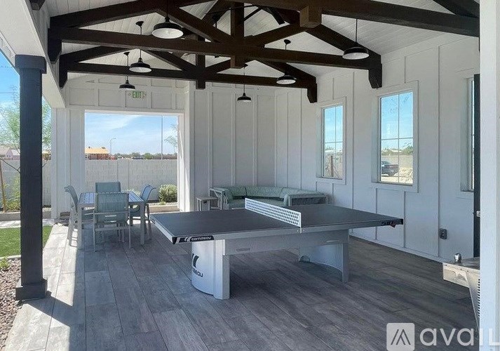 A house with a brown roof and a gravel driveway.