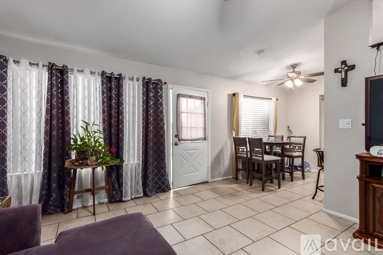 A living room with a purple couch and a television.