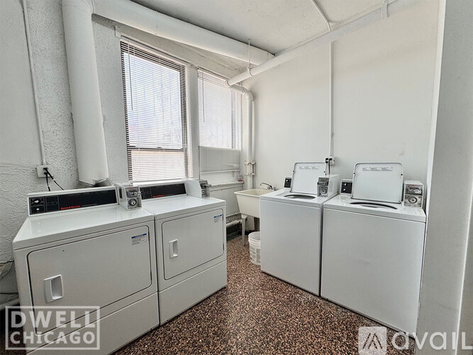 A kitchen with white cabinets and a wooden floor.