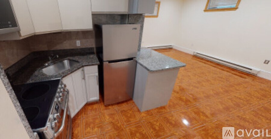 A kitchen with a refrigerator, dishwasher, and a sink.