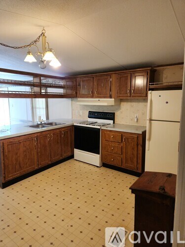A kitchen with wooden cabinets and a white fridge.
