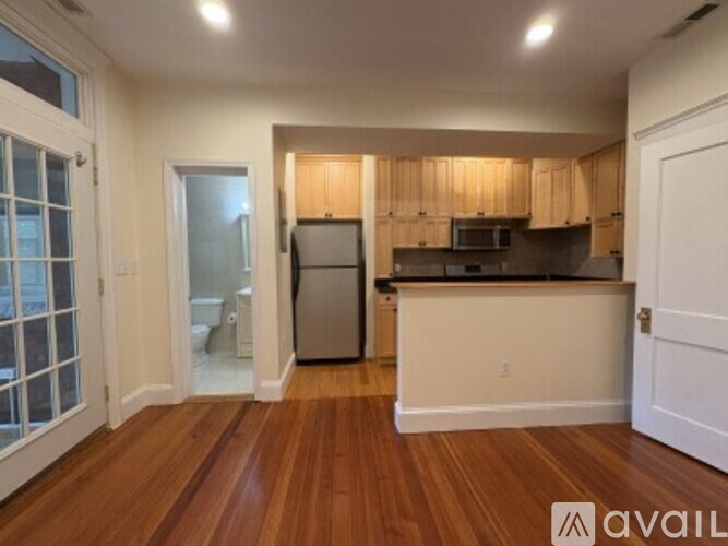 A kitchen with wooden cabinets and a refrigerator.