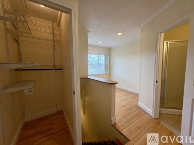 A room with wooden floors and a window is available for rent.