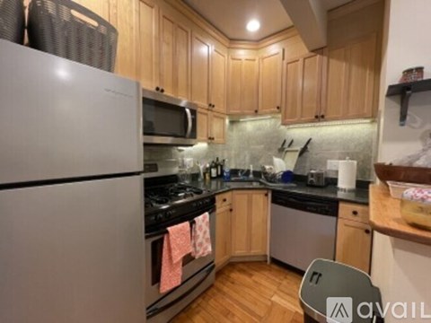 A kitchen with wooden cabinets and a white refrigerator.