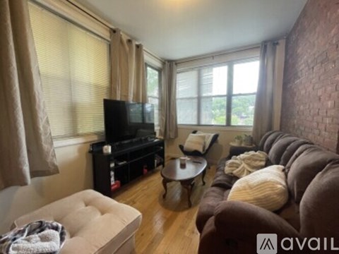 A living room with a brown couch, a television, and a coffee table.