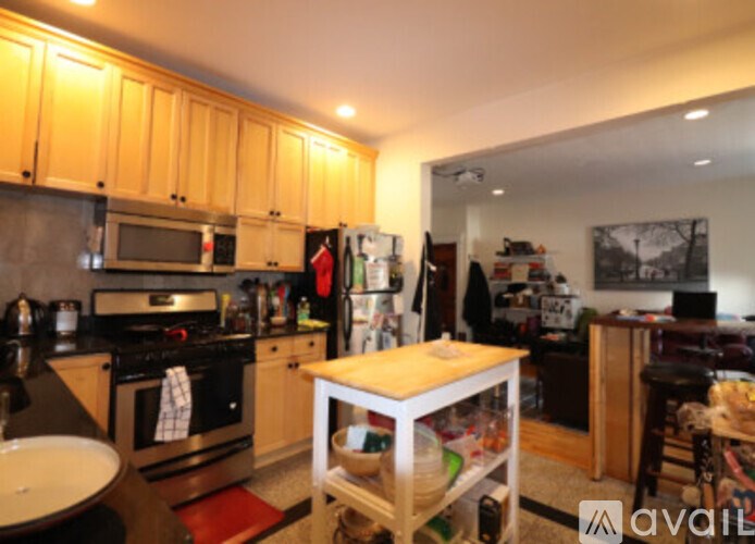 A kitchen with wooden cabinets and a stove top oven.