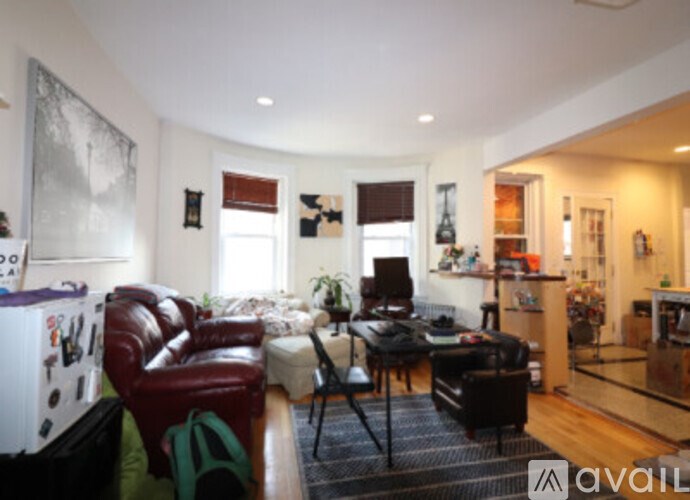 A living room with a red leather chair and a black table.