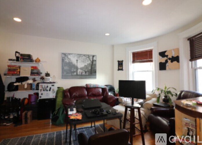 A living room with a couch, chair, and television.