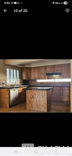 A kitchen with wooden cabinets and a black countertop.