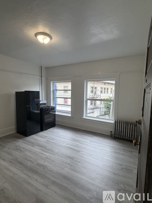 A room with a ceiling fan and wooden flooring.