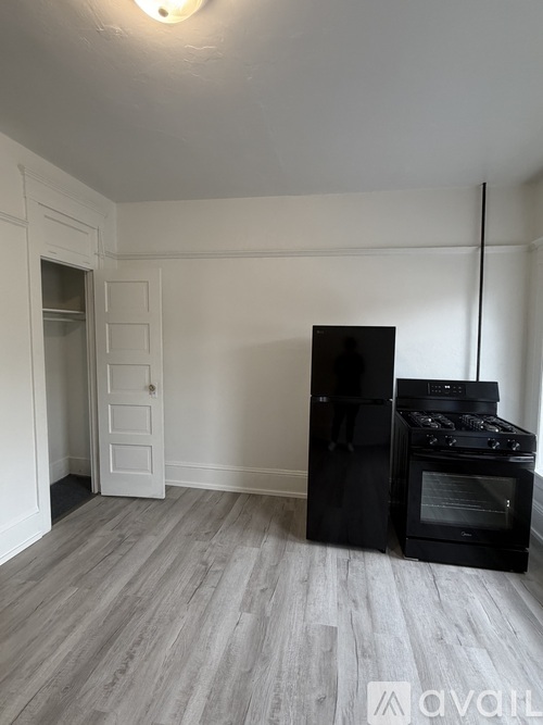A room with a ceiling fan and a door.