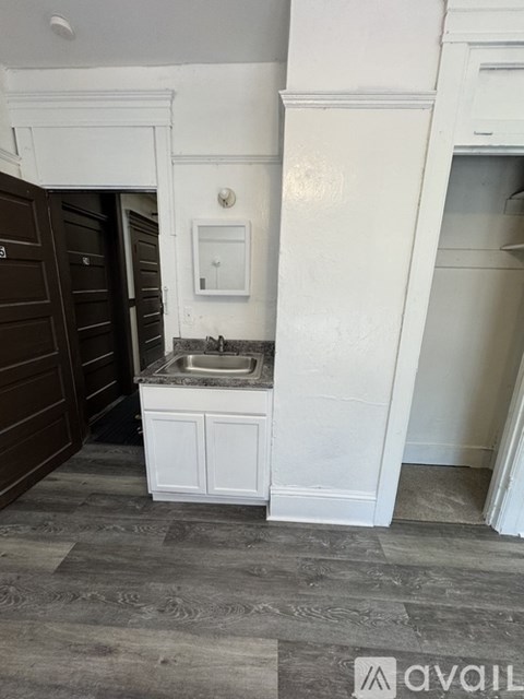A kitchen with a sink and a cabinet.