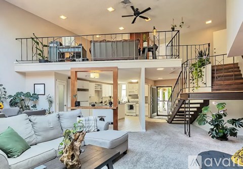 A living room with a grey couch and a wooden coffee table.