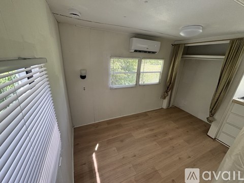 A kitchen with wooden floors and a white oven.