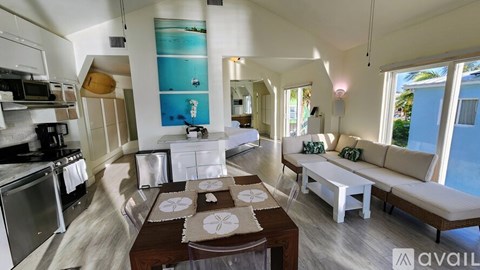 A kitchen with a dining table and a couch.