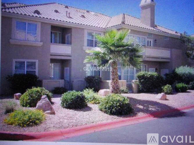 A building with a palm tree in front of it.
