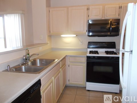 A kitchen with white cabinets and appliances.
