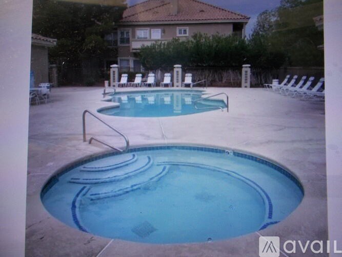 A pool with a hot tub in the middle of it.