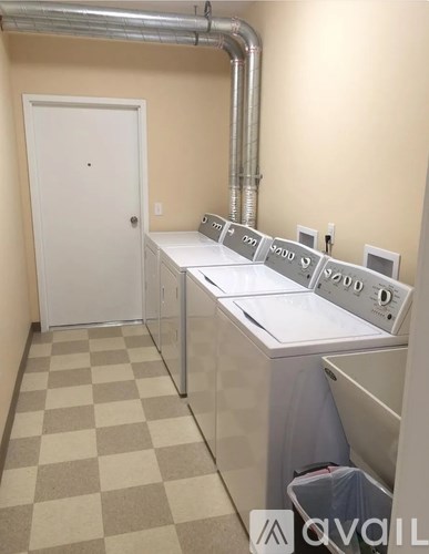 A laundry room with washers and dryers.