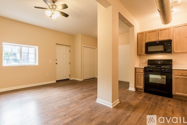 A yellow lawn mower sits on a green lawn.