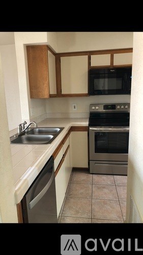 A kitchen with a stainless steel oven and microwave.