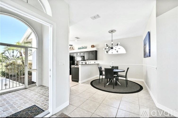 A dining area with a table set for two.