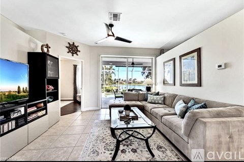 A living room with a large couch and a television.