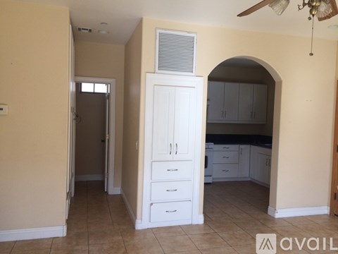 A kitchen with a white cabinet and drawers is available for rent.