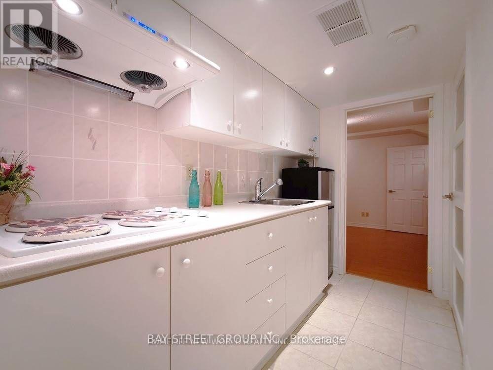 A kitchen with white cabinets and a sink.